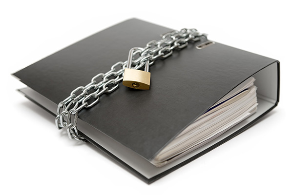 a binder of files chained with a padlock